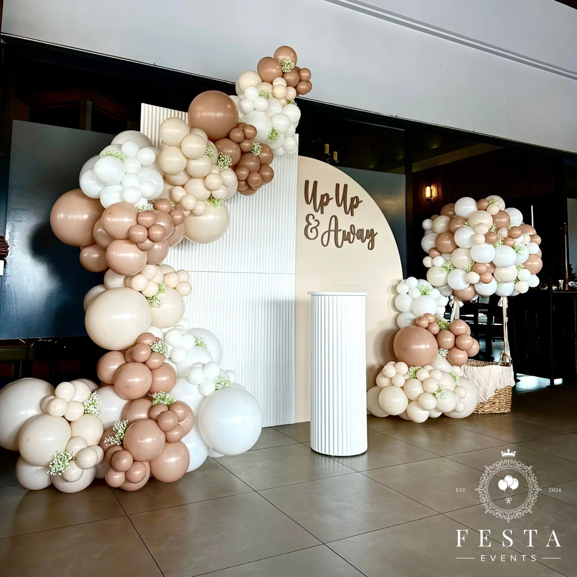 Baby shower 'Up Up & Away' backdrop with neutral balloon garlands and hot air balloon basket (Balloons created & designed by Time Flyz)